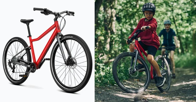 Rower młodzieżowy woom Explore 6 i chłopiec jeżdżący na nim po lesie